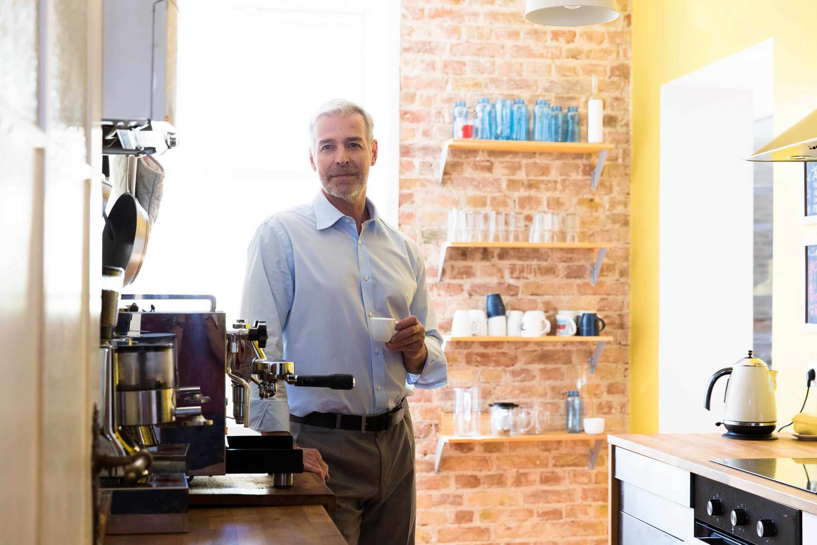businessman-having-coffee-break-in-office-kitchen-EPSSJ5W.jpg